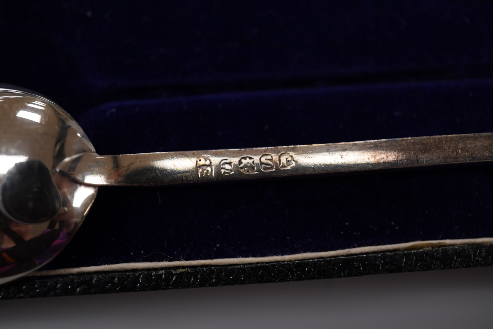 A George V silver Corinthian column candlestick, Birmingham, 1913, 16.1cm, a cased set of silver silver coffee spoons, two cased plated sets and a silver handled steel butter knife.